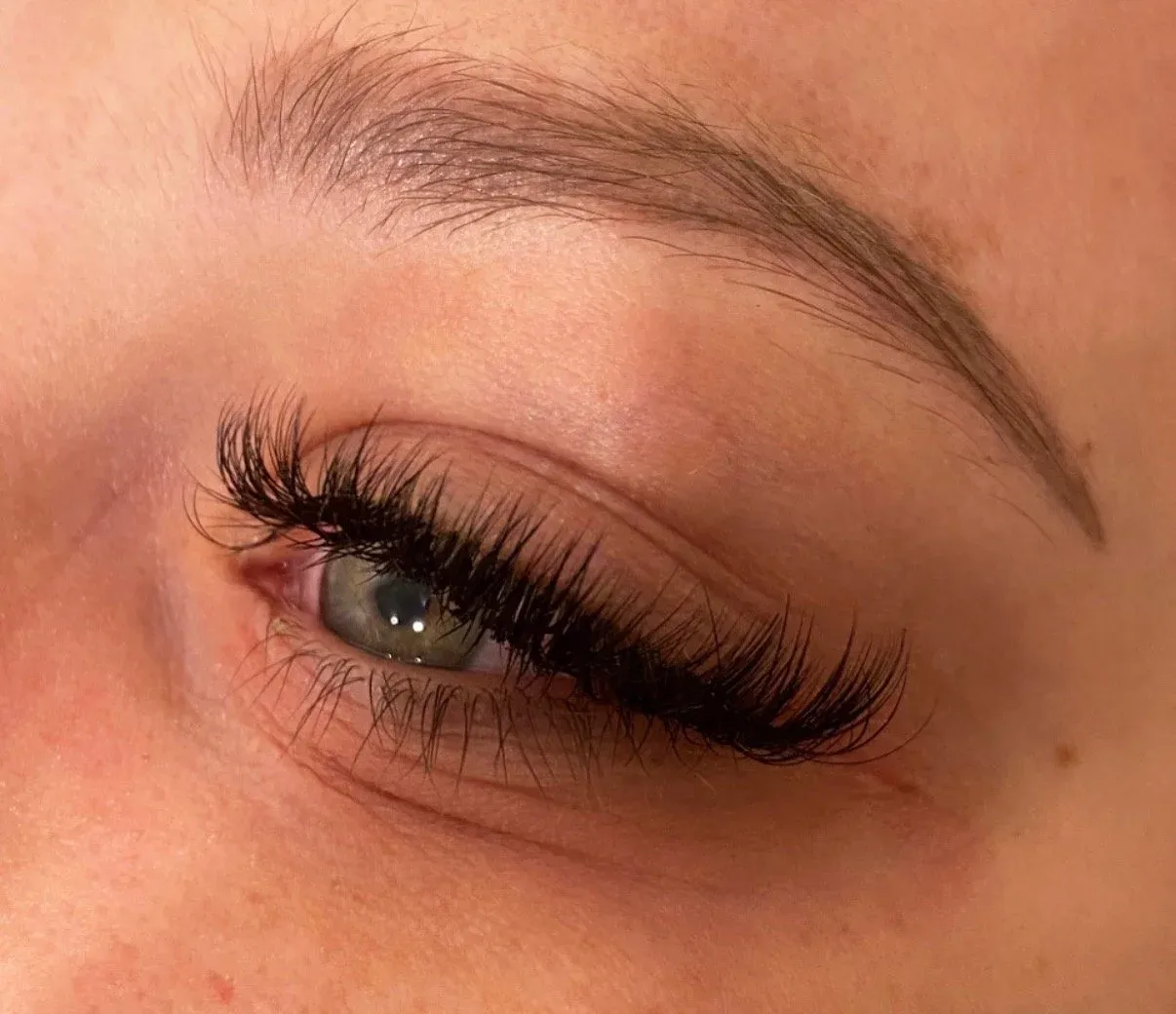Soft eyelash extensions blending seamlessly with natural lashes