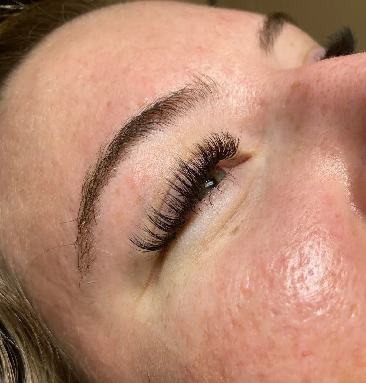 Full, fluffy volume lash extension result, close-up on the lash line